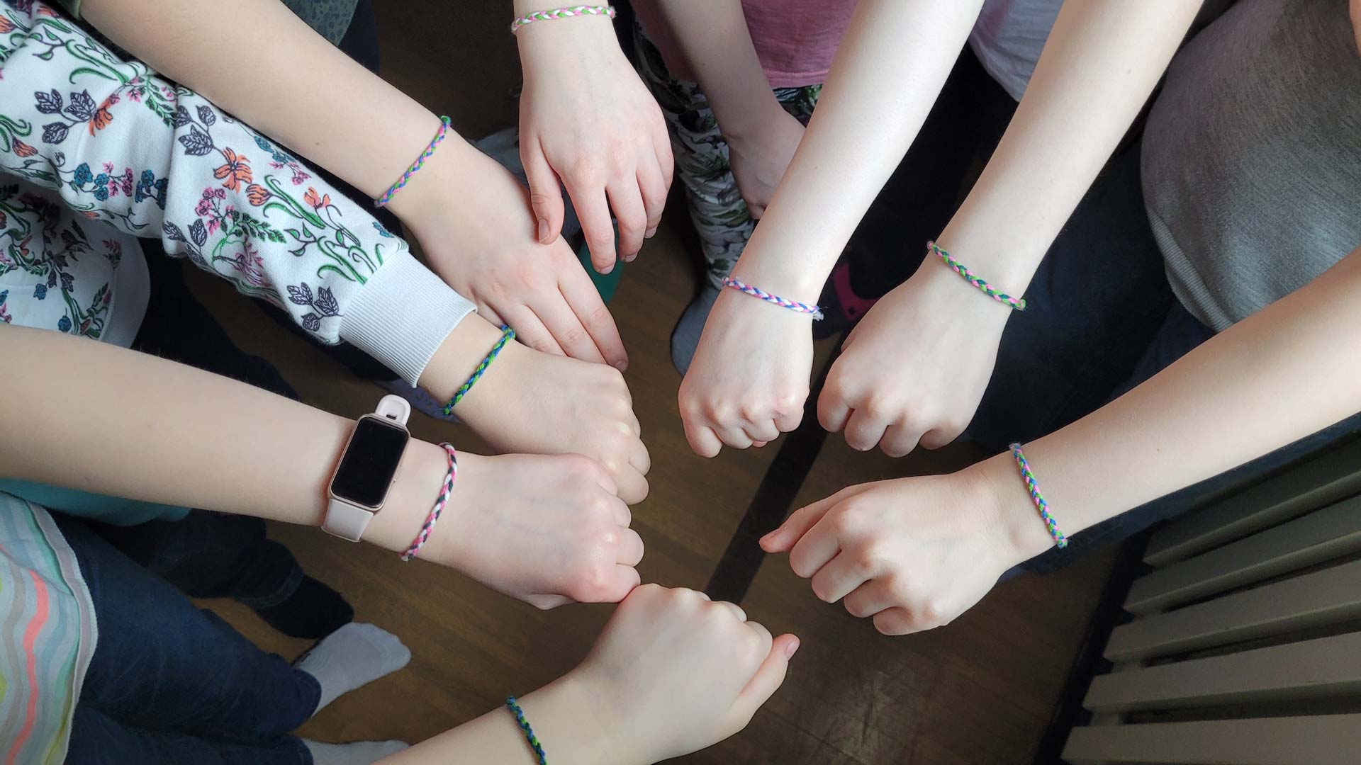 AURORA: Children wearing friendship bracelets